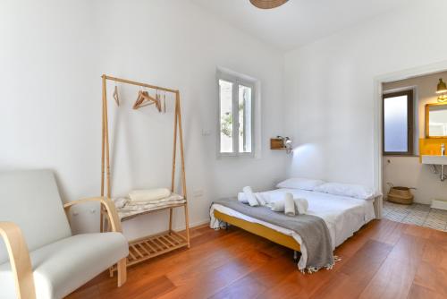 a bedroom with a bed and a mirror and a couch at Casa Magnolia in Campo nell'Elba