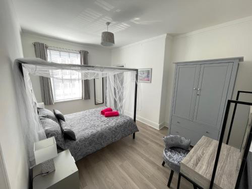 a bedroom with a bed with a canopy at Edith Haven Tynemouth Fabulous Coastal Holiday Home in Tynemouth