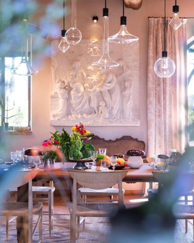 a dining room with a table and a painting on the wall at Paradis Agricole in Pietrasanta