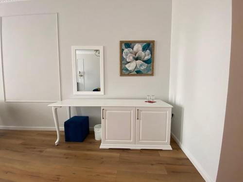 a white bathroom with a white vanity and a mirror at Pensiunea Korona in Miercurea-Ciuc
