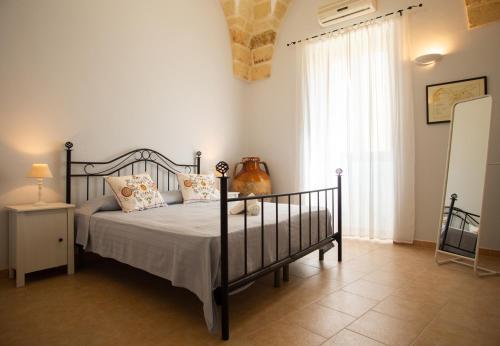 a bedroom with a bed and a large window at Sogni a Sud - The Fab Stay in Mesagne