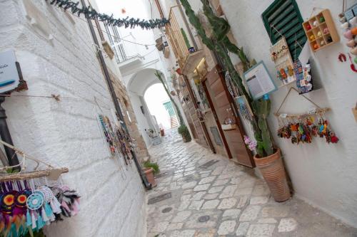 a narrow alley with an archway in a town at You & Me in Polignano a Mare