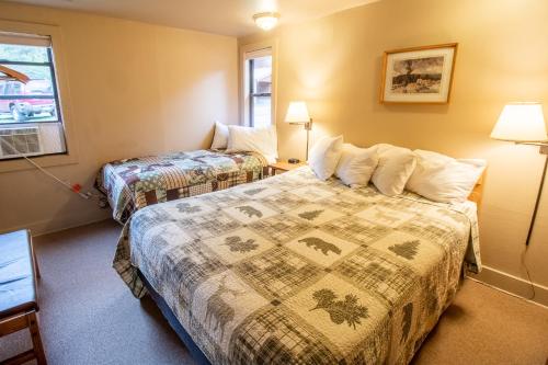 a hotel room with two beds and a window at Castle Mountain Lodge in Estes Park