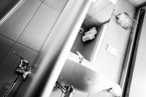 a bathroom with a sink and a mirror at The Originals Access Hôtel Bordeaux Aéroport in Mérignac