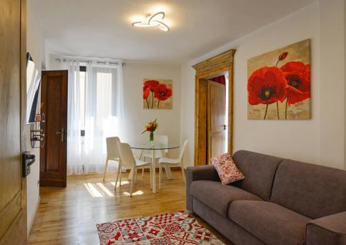a living room with a couch and a table at Ma Choupette in Torre Pellice