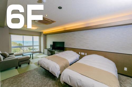 a hotel room with two beds and a large window at Ise-Shima Ohtaya Healing Stay in Toba