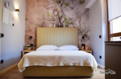 a bedroom with a large bed with a wall mural at GuerriniBNB Civico 5 in Manerbio