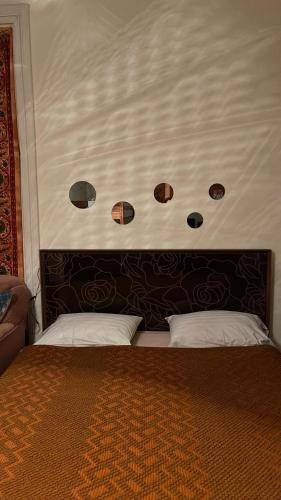 a bed with a headboard with four lights above it at Nana's Guest House in Sighnaghi