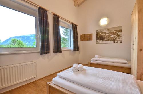 una camera con due letti e una finestra di Apartment Snowmountain - by Alpen Apartments a Zell am See