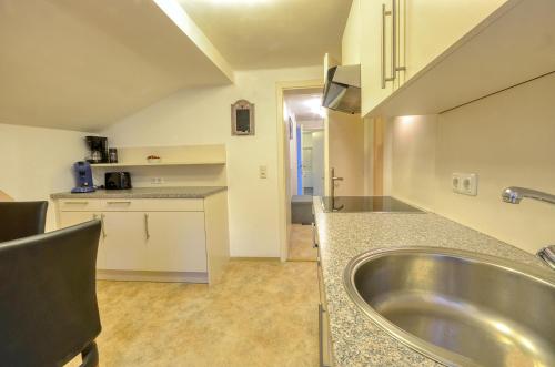 a kitchen with a sink and a counter top at Apartment Lisa - by Alpen Apartments in Zell am See