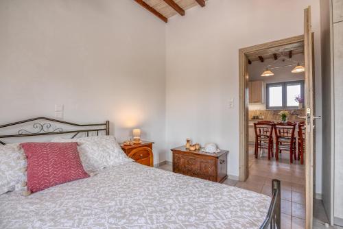 a bedroom with a bed and a dining room at Lahardi - Seaside House in Kissamos