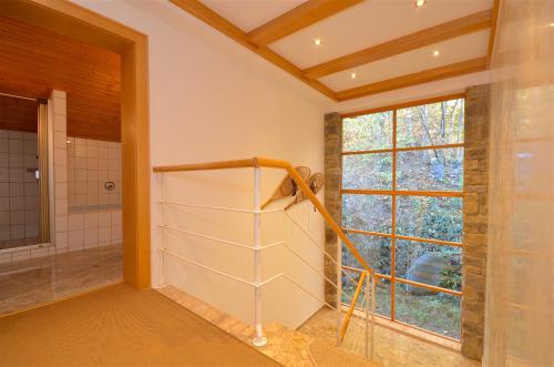 a bathroom with a walk in shower and a window at Haus Thumersbach - by Alpen Apartments in Zell am See