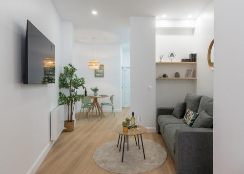 a living room with a couch and a table at KAIXO BILBAO APARTMENTS in Bilbao