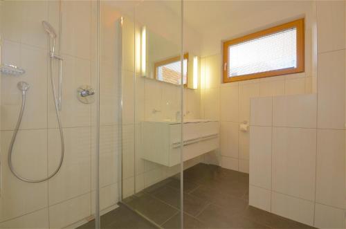 a bathroom with a shower and a glass shower stall at Sonnenhaus A - by Alpen Apartments in Zell am See