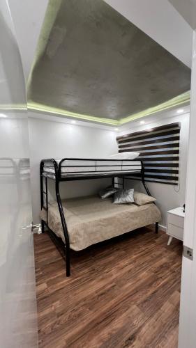 a bedroom with a bunk bed in a room at Baja Suites - Departamentos Vacacionales in Ensenada