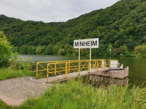 a sign on a bridge over a body of water at Fewo-Minheim Waltraud und Franz Bayer in Minheim