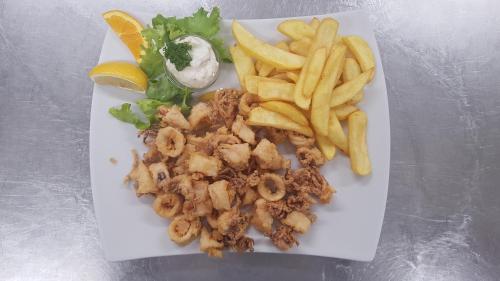 a white plate of food with french fries and shrimp at Guesthouse Pri Štefanu in Most na Soči