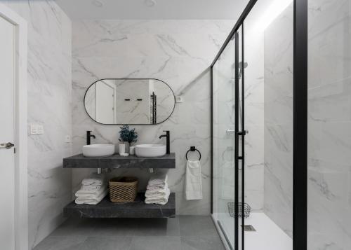 a bathroom with a sink and a mirror at KAIXO BILBAO APARTMENTS in Bilbao