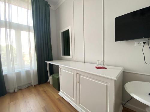 a bathroom with a white counter and a sink at Pensiunea Korona in Miercurea-Ciuc