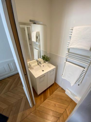 a bathroom with a sink and a mirror at Beautiful 3BR Apt in Lyon Center in Lyon