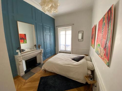a bedroom with a bed and a fireplace at Beautiful 3BR Apt in Lyon Center in Lyon