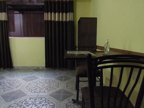 a room with a table and a chair and a desk at Hostal Pablo's House in Machu Picchu