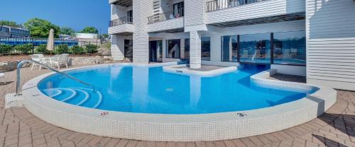a large swimming pool in front of a house at 359 Edgewater Inn in Charlevoix