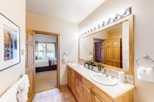 un bagno con due lavandini e un grande specchio di Mill Creek #203 a Keystone