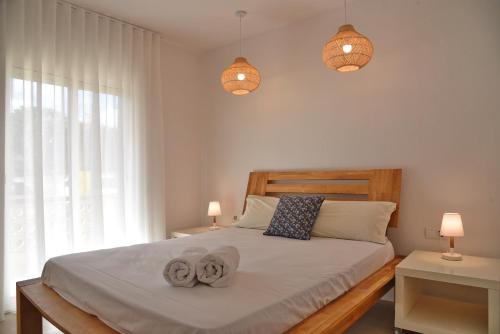 a bedroom with a bed with two towels on it at Apartament Luna in L'Escala