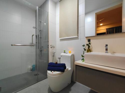 a bathroom with a toilet and a sink and a shower at Midvalley Luxury Maxine Suite in Kuala Lumpur
