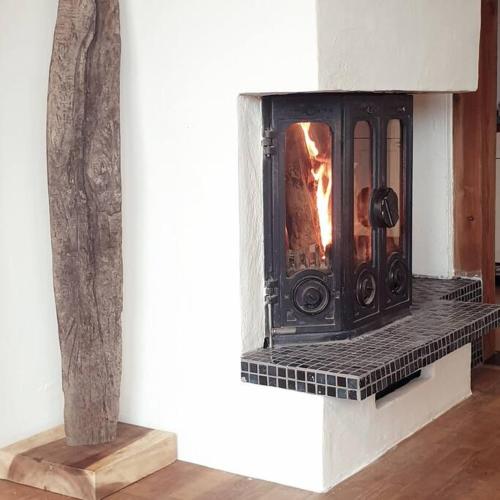 a fireplace with a fire in it in a room at Ferienwohnung Fam. Biechele in Rückholz