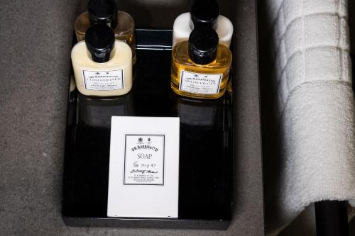 two bottles oficating sauce sitting in a box at Hotel Indigo London - 1 Leicester Square by IHG in London