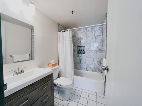 a bathroom with a toilet and a sink and a shower at Downtown Hartford Condo - XL Center in Hartford
