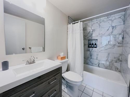 a bathroom with a sink and a toilet and a shower at Downtown Hartford Condo - XL Center in Hartford