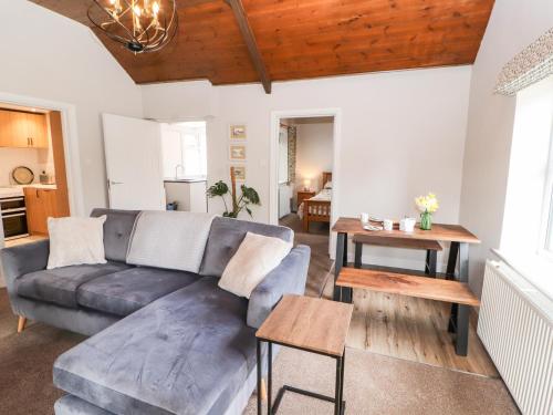 a living room with a couch and a table at The Flat in Carlisle