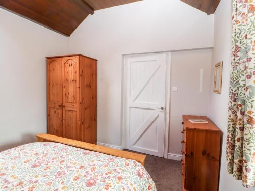 a bedroom with a bed and a closet and a door at The Flat in Carlisle