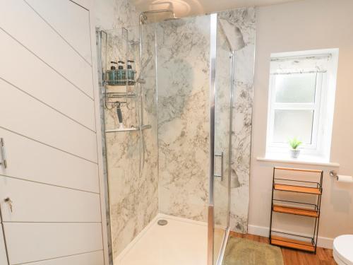 a shower with a glass door in a bathroom at The Flat in Carlisle