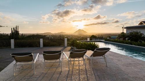 a group of chairs sitting next to a swimming pool at Sombre 14-E in Santa Cruz
