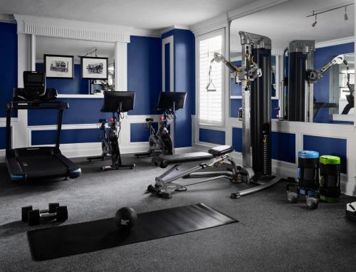 a gym with blue walls and exercise equipment at The Georgian Hotel in Los Angeles
