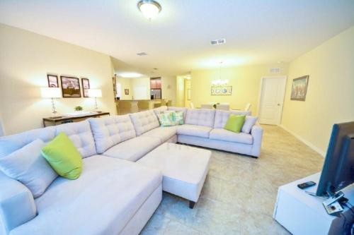 a living room with a white couch and a tv at Make memories with your family and friends in this beautiful home 1014 in Loughman