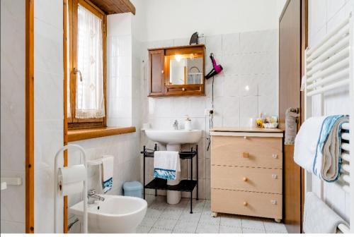 a white bathroom with a sink and a toilet at B&B Il Ghiro-Country House in Mormanno