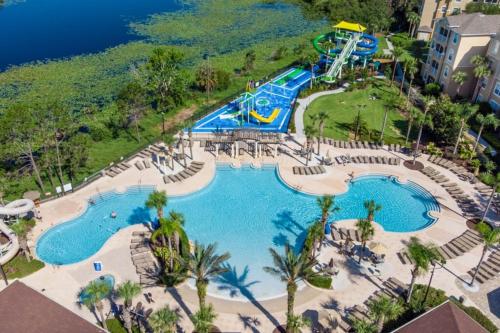 an aerial view of a pool at a resort at LUXURIOUS CONDO - JUST 2 MILES FROM DISNEY #404 in Orlando