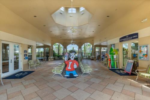 a large building with a lobby with a mickey mouse mural at LUXURIOUS CONDO - JUST 2 MILES FROM DISNEY #404 in Orlando