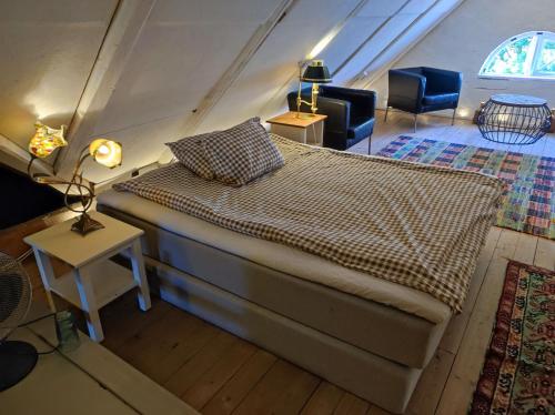 a bedroom with a large bed in a attic at The Garden Hill Hotel in Vallåkra