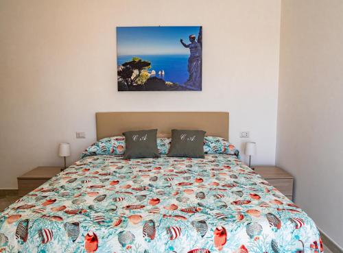 a bedroom with a bed with a picture on the wall at Casa Astra in Anacapri