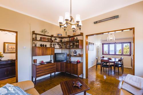 a living room with a table and a dining room at Casa à Beira Mar - Countryhouse with Ocean view in São Pedro da Cadeira