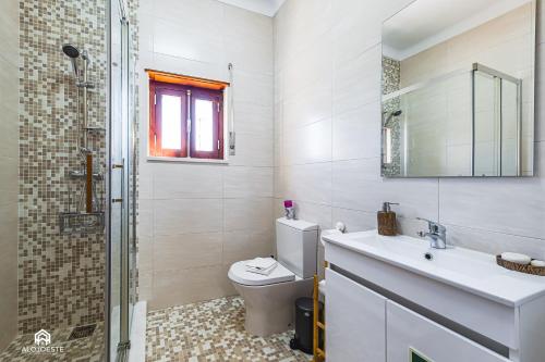 a bathroom with a toilet and a sink and a shower at Casa à Beira Mar - Countryhouse with Ocean view in São Pedro da Cadeira