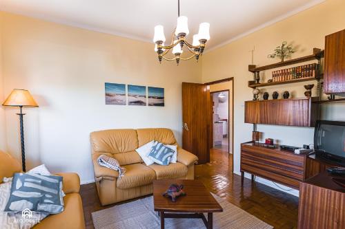 a living room with a couch and a tv at Casa à Beira Mar - Countryhouse with Ocean view in São Pedro da Cadeira
