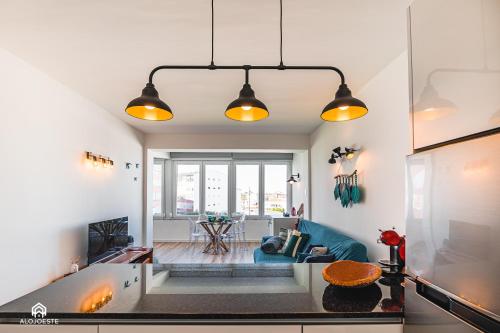 a living room with white walls and a blue couch at Casa MarAzul - Santa Cruz in Santa Cruz