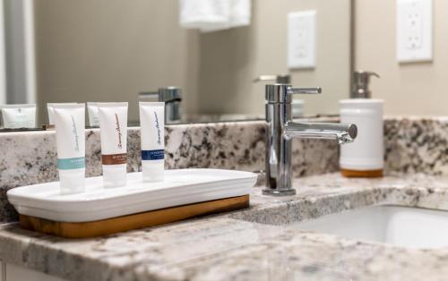 a toothbrush holder with toothbrushes on a bathroom counter at Island Villa- Your Padre Island Escape in Padre Island